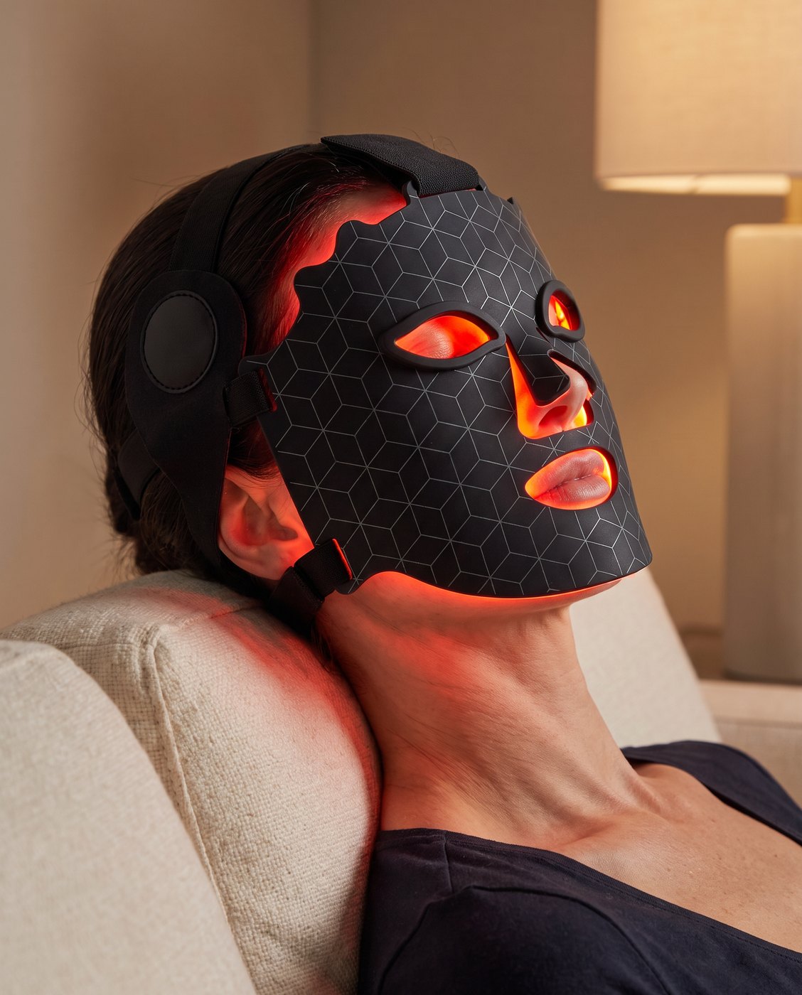 A woman relaxing in the Elysium LED face mask